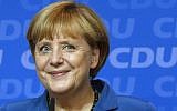 A victorious German Chancellor Angela Merkel smiles as she addresses supporters at the party headquarters in Berlin, Germany, Sunday, Sept. 22, 2013. (photo credit: AP Photo/Michael Sohn)