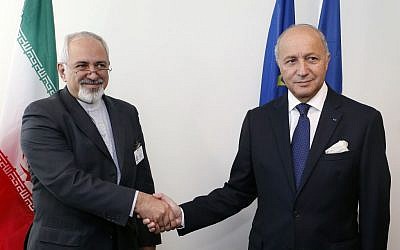 Iranian Foreign Minister Mohammad Javad Zarif, left, and French Foreign Minister Laurent Fabius shake hands before conducting a bilateral meeting during the 68th session of the United Nations General Assembly at UN headquarters, Wednesday, September 25, 2013. (photo credit: AP/Jason DeCrow)