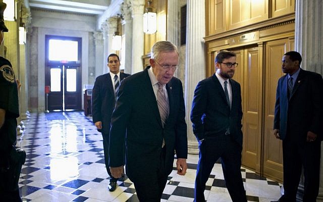 US Senate Majority Leader Harry Reid of Nevada makes his way to the Senate floor on Capitol Hill in Washington on Friday, Sept. 6, 2013, to introduce a resolution to authorize military action to support President Barack Obama's request for a strike against Syria. (photo credit: AP Photo/J. Scott Applewhite) US Senate Majority Leader Harry Reid of Nevada makes his way to the Senate floor on Capitol Hill in Washington on Friday, Sept. 6, 2013, to introduce a resolution to authorize military action to support President Barack Obama's request for a strike against Syria. (photo credit: AP Photo/J. Scott Applewhite)