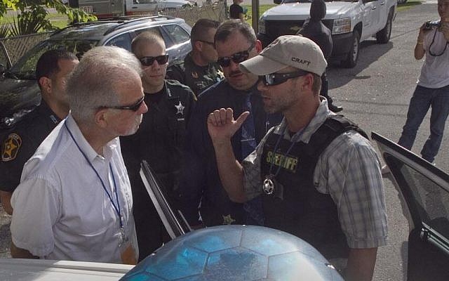 Pastor Terry Jones is arrested on his way to burn 2,998 Qurans to mark the anniversary of the 9/11 attacks on Wednesday, in Mulberry, Florida (photo credit: @theledger via Twitter) Pastor Terry Jones is arrested on his way to burn 2,998 Qurans to mark the anniversary of the 9/11 attacks on Wednesday, in Mulberry, Florida (photo credit: @theledger via Twitter)