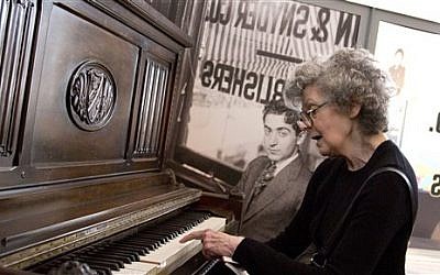 Linda Emmet, the daughter of musician Irving Berlin, plays on her father's piano at the Red Star Line museum in Antwerp, Belgium on Thursday, Sept. 26, 2013. (photo credit: AP Photo/Virginia Mayo)