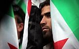 A Syrian immigrant who lives in Bulgaria observes a minute of silence during a demonstration in front of the European Commission Representation office in Sofia, Bulgaria, Saturday, Aug. 31, 2013 (photo credit: AP/Valentina Petrova)