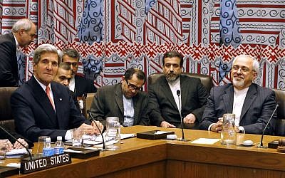 US Secretary of State John Kerry (left), and Iranian Foreign Minister Mohammad Javad Zarif (right) attend a meeting of the five permanent members of the Security Council plus Germany during the 68th session of the United Nations General Assembly at UN headquarters, Thursday, September 26, 2013. (photo credit: AP/Jason DeCrow)