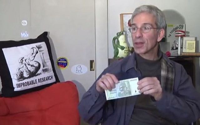 Annals of Improbable Research editor Eric Abrahams shows off this year's new cash prize. (photo credit: YouTube screenshot) Annals of Improbable Research editor Eric Abrahams shows off this year's new cash prize. (photo credit: YouTube screenshot)