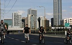 People ride their bicycles on the car-free Ayalon highway in Tel Aviv on Yom Kippur (Photo credit: Miriam Alster/Flash90)