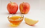 Apple in honey (illustrative photo credit: Mendy Hechtman/Flash90)