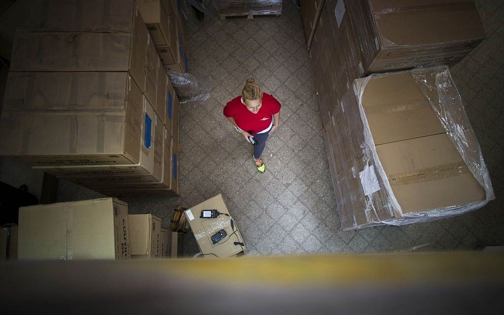 A postal service employe walks next to columns of gas mask kits at a distribution center in Jerusalem, August 29, 2013 (photo credit: Flash90) A postal service employe walks next to columns of gas mask kits at a distribution center in Jerusalem, August 29, 2013 (photo credit: Flash90)
