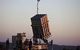 Israeli soldiers walk by an Iron Dome missile defense system deployed near Jerusalem, September 2013. (photo credit Flash90)
