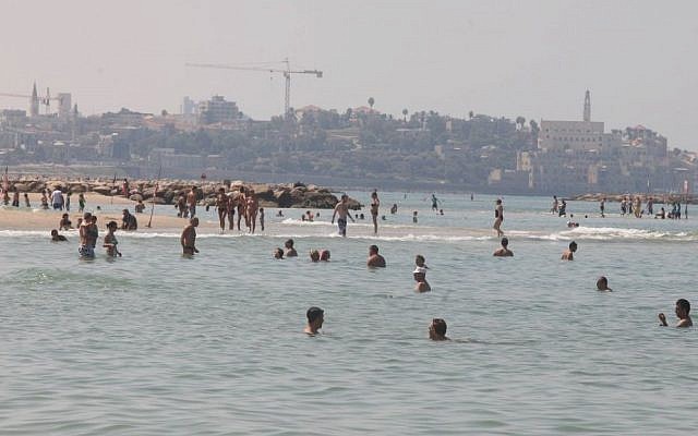 Israelis enjoy a hazy late-summer beach day in Tel Aviv, last week (photo credit: Roni Schutzer/Flash90) Israelis enjoy a hazy late-summer beach day in Tel Aviv, last week (photo credit: Roni Schutzer/Flash90)