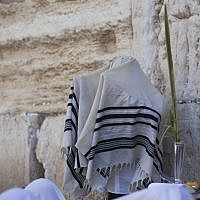 A religious Jew of the priestly caste spreads his prayer shawl over his head as he takes part in a mass prayer in front of the Western Wall in Jerusalem, Sunday, September 22, 2013 (photo credit: Yonatan Sindel/Flash90)