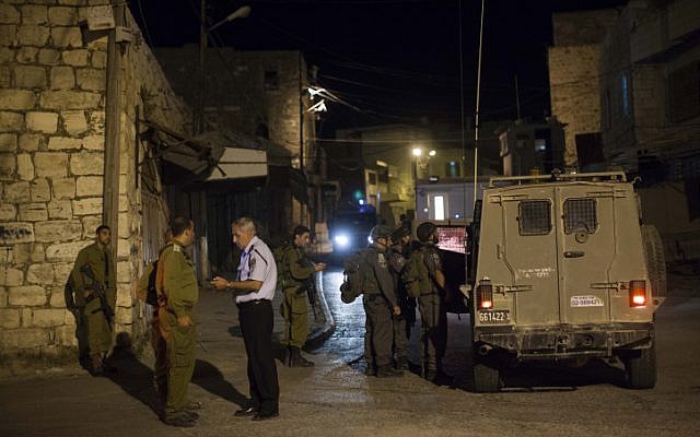 Israeli soldiers stand near the scene of a shooting in the city of Hebron on September 22, 2013 (photo credit: Yonatan Sindel/Flash90) Israeli soldiers stand near the scene of a shooting in the city of Hebron on September 22, 2013 (photo credit: Yonatan Sindel/Flash90)
