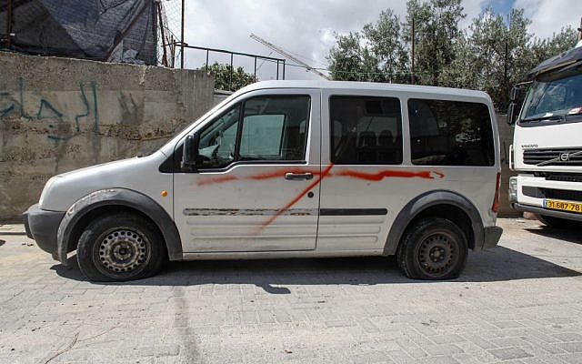 One of the vehicles vandalized in the Sheikh Jarrah neighborhood of Jerusalem, on September 22, 2013. (photo credit: Flash90) One of the vehicles vandalized in the Sheikh Jarrah neighborhood of Jerusalem, on September 22, 2013. (photo credit: Flash90)