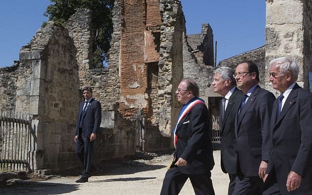 From left, Mayor of Oradour-sur-Glane, Raymond Fugier, German President Joachim Gauck, French President Francois Hollande and Robert Hebras, one of the two survivors still alive, walk through the ghost city of Oradour-sur-Glane, southwestern France, Wednesday, Sept. 4, 2013, where on June 10, 1944, the Nazis massacred 642 civilians. (photo credit: AP Photo/Michel Euler, Pool) From left, Mayor of Oradour-sur-Glane, Raymond Fugier, German President Joachim Gauck, French President Francois Hollande and Robert Hebras, one of the two survivors still alive, walk through the ghost city of Oradour-sur-Glane, southwestern France, Wednesday, Sept. 4, 2013, where on June 10, 1944, the Nazis massacred 642 civilians. (photo credit: AP Photo/Michel Euler, Pool)