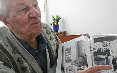 In this March 10, 2005 file photo Hitler's bodyguard Rochus Misch points to a picture of Adolf Hitler he had taken in Berchtesgarden, southern Germany, in the early 1940th in his house in Berlin. Misch, who was the last remaining witness to the Nazi leader's final hours in his Berlin bunker, died Thursday, Sept. 5, 2013. He was 96. (AP Photo/Herbert Knosowski, File)