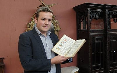 Forrest holding the 'Manchester Garage Haggadah' (photo credit: courtesy) Forrest holding the 'Manchester Garage Haggadah' (photo credit: courtesy)