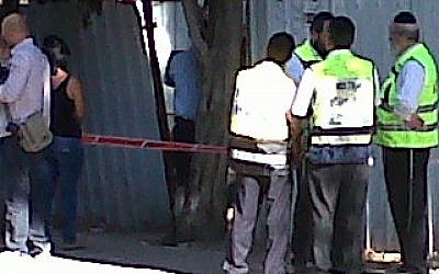 Police and rescuers at the scene of the murder. (photo credit: Philip Brooke)