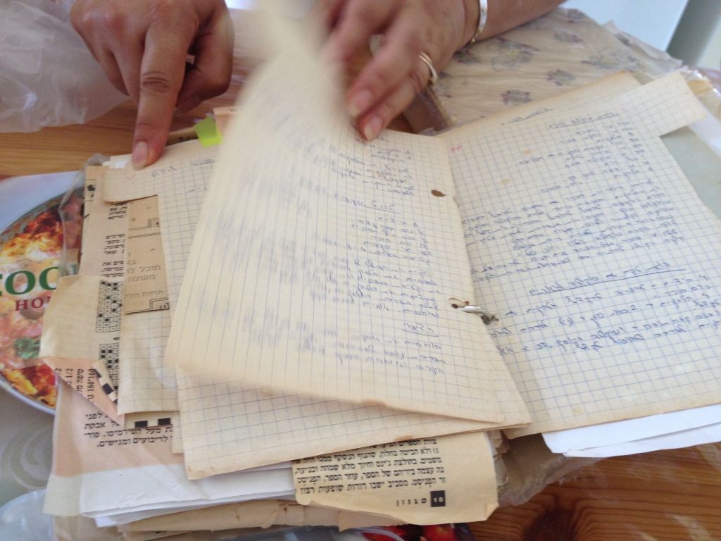Thumbing through one of the many recipe notebooks in Ziv's collection (photo credit: Jessica Steinberg/Times of Israel)