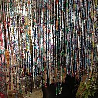 Handmade paper beads rolled by Cheryl Matthews and then strung into a curtain (photo credit: Jessica Steinberg/Times of Israel)