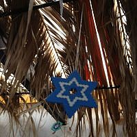 The only Sukkah decorations left from the Matthews' kids are these ironed bead decals, hung in the dining room portion of their three-room sukkah (photo credit: Jessica Steinberg/Times of Israel)