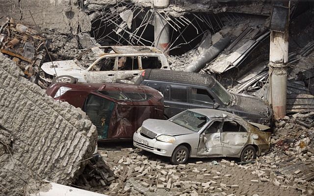 This photo released by the Kenya Presidency shows the collapsed upper car park of the Westgate Mall in Nairobi, Kenya Thursday, September 26, 2013. Working near bodies crushed by rubble in a bullet-scarred, scorched mall, FBI agents continued fingerprint, DNA and ballistic analysis to help determine the identities and nationalities of victims and al-Shabab gunmen who attacked the shopping center, killing more than 60 people. (photo credit: AP Photo/Kenya Presidency)
