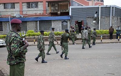 Kenya security personnel walk to their positions outside a shopping mall in Nairobi, Kenya, Sunday, Sept. 22, 2013 (photo credit: AP/Sayyid Azim)