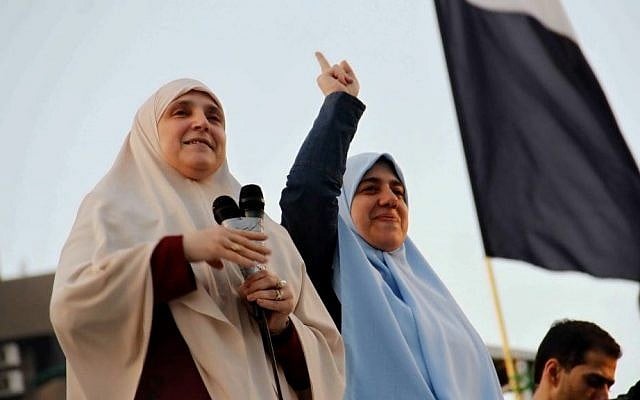 Naglaa Mahmoud, left, the wife of Egypt's ousted president Mohammed Morsi, alongside her daughter, addresses thousands of Morsi supporters gathered at a sit-in in Cairo's Nasr City, in August (photo credit: AP/Ravy Shaker/El Shorouk Newspaper/File) Naglaa Mahmoud, left, the wife of Egypt's ousted president Mohammed Morsi, alongside her daughter, addresses thousands of Morsi supporters gathered at a sit-in in Cairo's Nasr City, in August (photo credit: AP/Ravy Shaker/El Shorouk Newspaper/File)