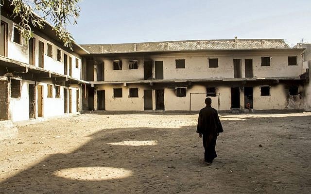An Egyptian priest walks in the courtyard of the guesthouse of the Virgin Mary and St. Abraam Monastery, that was looted and burned by Islamists, in Dalga, Minya province, Egypt. (AP Photo/El Shorouk Newspaper, Roger Anis)