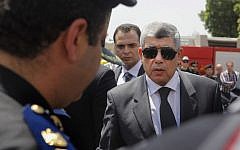 In this Thursday, Aug. 15, 2013, file photo, Egyptian Interior Minister Mohammed Ibrahim, right, gives his condolences to a policeman during a military funeral in Cairo, Egypt. (Photo credit: AP/Amr Nabil, File)