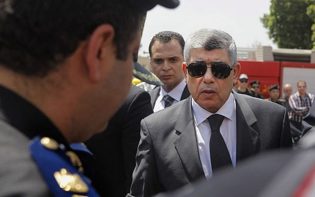In this Thursday, Aug. 15, 2013, file photo, Egyptian Interior Minister Mohammed Ibrahim, right, gives his condolences to a policeman during a military funeral in Cairo, Egypt. (Photo credit: AP/Amr Nabil, File) In this Thursday, Aug. 15, 2013, file photo, Egyptian Interior Minister Mohammed Ibrahim, right, gives his condolences to a policeman during a military funeral in Cairo, Egypt. (Photo credit: AP/Amr Nabil, File)