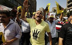 A supporter of the Muslim Brotherhood wears a shirt with the pro-MB symbol, during a march in Cairo, Egypt, on September 6, 2013. (AP/Lefteris Pitarakis)