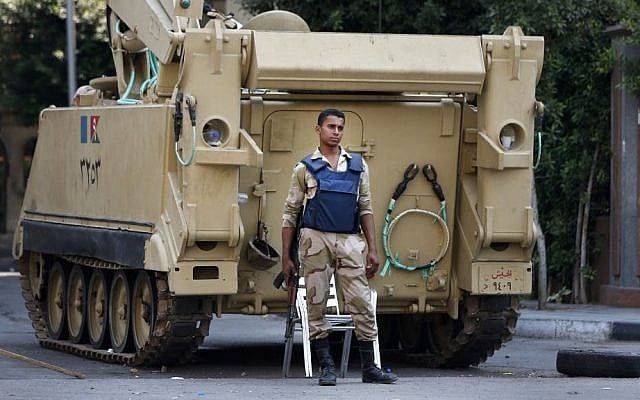 An Egyptian soldier stands guard next to an armored personnel carrier in Cairo, Egypt, on Tuesday, September 10, 2013. (photo credit: AP Photo/Lefteris Pitarakis) An Egyptian soldier stands guard next to an armored personnel carrier in Cairo, Egypt, on Tuesday, September 10, 2013. (photo credit: AP Photo/Lefteris Pitarakis)