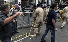 Members of Lebanon's Hezbollah group remove one of their checkpoints in a southern suburb of Beirut, Lebanon, Monday, Sept. 23, 2013. (Photo credit: AP/Bilal Hussein)