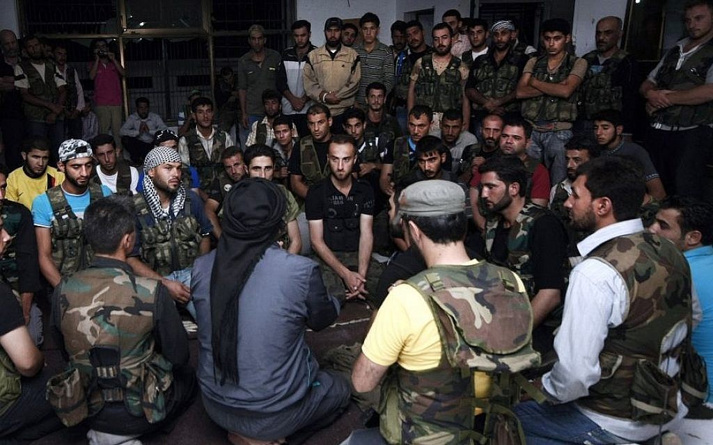 In this July 29, 2012, photo, Free Syrian Army soldiers gather at the border town of Azaz, some 20 miles (32 kilometers) north of Aleppo, Syria. Al-Qaida-linked gunmen in northern Syria captured the town near the Turkish border on Thursday, Sept. 19, 2013, following heavy clashes with mainstream, Western-backed rebels in the area, prompting Turkey to close a nearby crossing, activists and Turkish officials said. (AP Photo/Turkpix, File) In this July 29, 2012, photo, Free Syrian Army soldiers gather at the border town of Azaz, some 20 miles (32 kilometers) north of Aleppo, Syria. Al-Qaida-linked gunmen in northern Syria captured the town near the Turkish border on Thursday, Sept. 19, 2013, following heavy clashes with mainstream, Western-backed rebels in the area, prompting Turkey to close a nearby crossing, activists and Turkish officials said. (AP Photo/Turkpix, File)