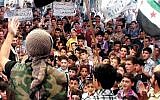 A Syrian protester chants slogans during a demonstration in Arbeen town, a suburb of Damascus, Syria, Friday, Sept. 13, 2013 (photo credit: AP)