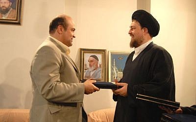 Siamak Moreh Sedgh (left), greets Sayyed Hassan Khomeini, grandson of Ayatollah Ruhollah Khomeini, the founder of the Islamic Republic of Iran. (photo credit: Website of Iran's Jewish community)