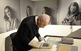 President Shimon Peres reviews original segments from the diary of Anne Frank during a visit to Amsterdam, September 30, 2013. (photo credit: Facebook/Shimon Peres)