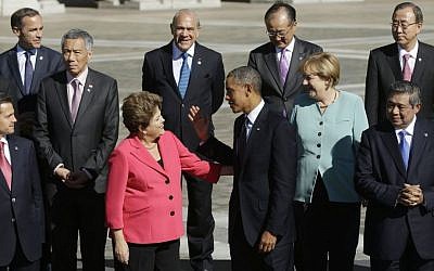 US President Barack Obama, center, talks with Brazil's President Dilma Rousseff as he join with other leaders for the group photo at the G-20 summit at the Konstantin Palace in St. Petersburg, Russia, Friday, Sept. 6, 2013. (AP Photo/Pablo Martinez Monsivais)