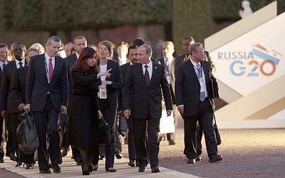 Russia's President Vladimir Putin, front center right, speaks with Argentina's President Cristina Fernandez de Kirchner, front center left, as they walk with other G-20 leaders toward a dinner at the Peterhof Palace in St. Petersburg, Russia on Thursday. (AP Photo/Ivan Sekretarev)