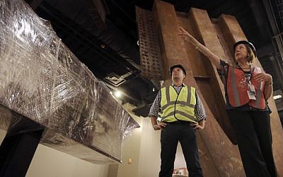Joe Daniels, left, 9/11 Memorial president, and museum director Alice Greenwald speak to reporters during a media tour of the National September 11 Memorial and Museum, Friday, Sept. 6, 2013 in New York. Construction is racing ahead inside the museum as the 12th anniversary of the Sept. 11, 2001 attacks draws near. Several more large artifacts have been installed in the cavernous space below the World Trade Center memorial plaza. (photo credit: AP Photo/Mary Altaffer)