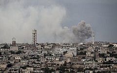 Smoke rises after a bomb was thrown from a helicopter, hitting a rebel position during heavy fighting between troops loyal to president Bashar Assad and opposition fighters, in Idlib province, Syria Thursday, Sept. 19, 2013 ,(photo credit: AP)