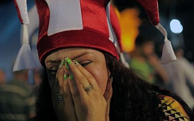A Turkish woman reacts in Sultan Ahmed Square in Istanbul, Turkey, on Saturday, September 7, 2013 on seeing the results of the Olympics vote. (photo credit: AP Photo)