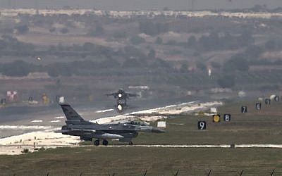 A US Air Force plane takes off as a Turkish Air Force fighter jet taxis at the Incirlik airbase, southern Turkey, Sunday, Sept. 1, 2013. (photo credit: AP/Vadim Ghirda)