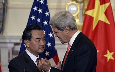 Secretary of State John Kerry, right, and Chinese Foreign Minster Wang Yi, left, talk before making statements before their bilateral meeting at the State Department in Washington, Thursday, Sept. 19, 2013. (Photo credit: AP/Susan Walsh)