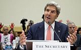 Protesters hold up red painted hands behind US Secretary of State John Kerry as he testifies on Capitol Hill in Washington, Wednesday (photo credit: AP/Carolyn Kaster)