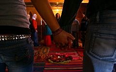A couple hold hands at a gathering of Jewish and Arab youth. (photo credit: Chen Leopold/Flash90)
