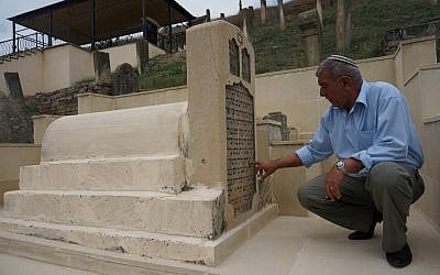 Yedidia Yehuda at the foot of the tomb of Rabbi Gershon ben Reuven in Krasnaiya Sloboda, August 2013. (photo credit: Cnaan Liphshiz/JTA)