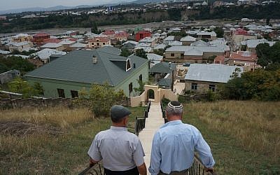 Yedidia Yehuda, right, and a childhood friend walking down the stairs that overlook Krasnaiya Sloboda, August 2013. (photo credit: Cnaan Liphshiz/JTA)