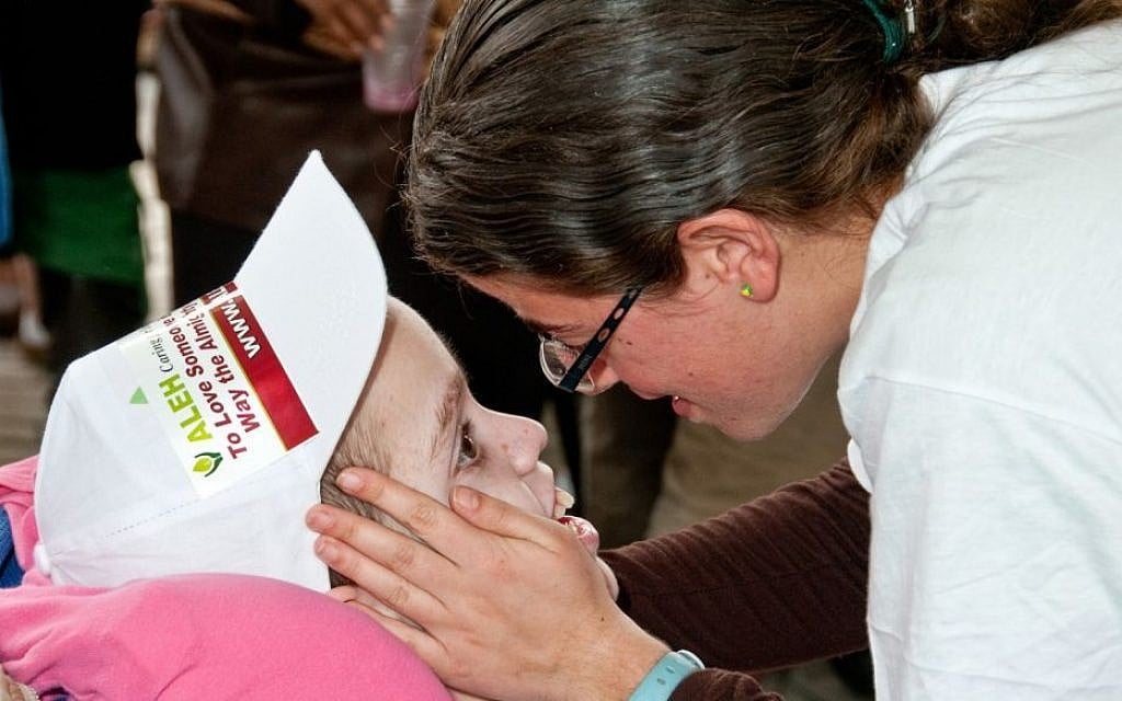 An ALEH child and his caregiver (photo credit: courtesy Aleh)