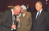 Yitzhak Rabin, left, chats with Yasser Arafat, center, and Shimon Peres after the three received the Nobel Peace Prize in Oslo in 1994. (GPO)