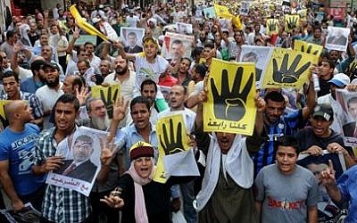 Supporters of Egypt's ousted President Mohammed Morsi hold a demonstration in Helwan, a suburb of Cairo, Egypt, Friday, September 27, 2013 (photo credit: AP /Mohammed Asad)